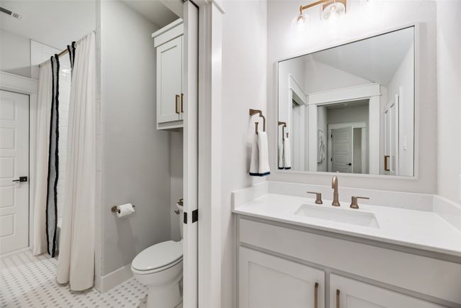 Full bath with toilet, tile patterned floors, vanity, baseboards, and a shower with curtain | Image 31