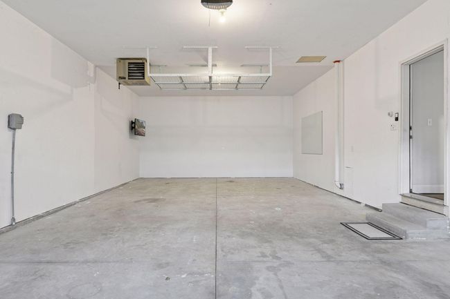 Four car heated garage! Sellers had a workout space in the back with a tv. | Image 25