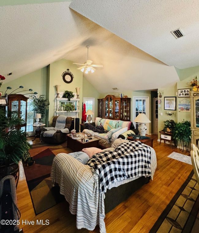 Open to Kitchen and Dining w/ Fireplace and door out to screen porch | Image 4