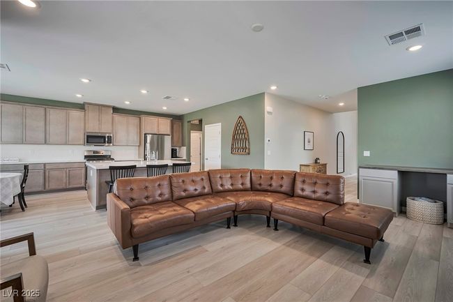 Living area with visible vents, light wood-style floors, and recessed lighting | Image 5