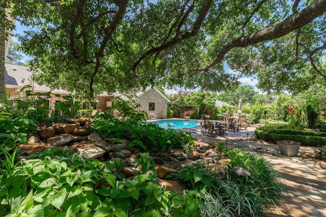 View of back of house and pool from behind cascading waterfall | Image 37
