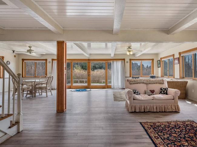 Wide-open floor plan with a large slider and many windows to enjoy panoramic views. | Image 5
