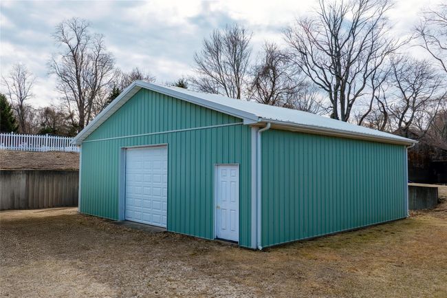 Detached garage featuring fence | Image 19