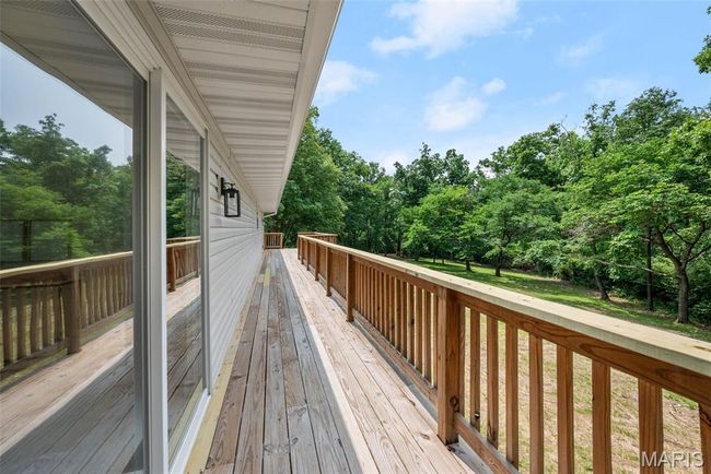 Deck featuring view of wooded area | Image 46