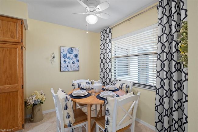 Dining space featuring ceiling fan and light tile patterned floors | Image 11