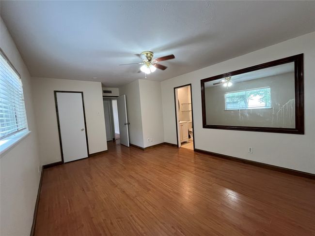 Unfurnished room featuring wood finished floors, a ceiling fan, and baseboards | Image 11