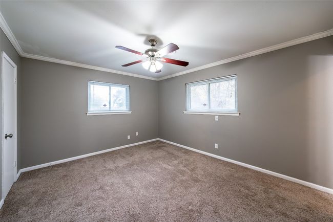 Carpeted spare room with healthy amount of natural light, crown molding, and ceiling fan | Image 19