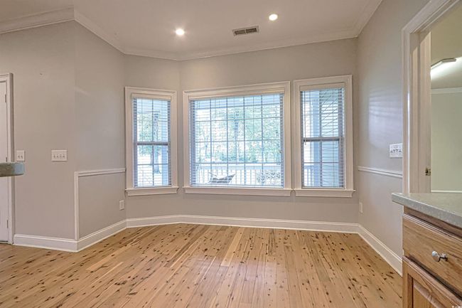 Unfurnished room featuring crown molding, light wood-style flooring, and recessed lighting | Image 9