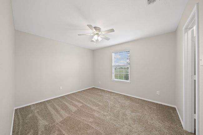 Spare room featuring ceiling fan and carpet flooring | Image 32