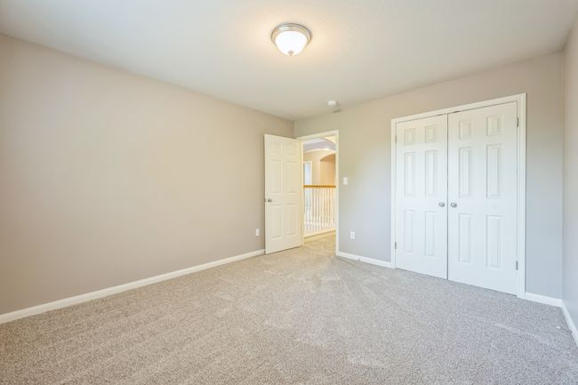 Unfurnished bedroom featuring baseboards, a closet, and light colored carpet | Image 23