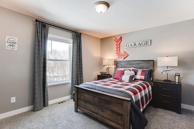 Each of the home's secondary bedrooms on the upper level come perfectly sized and all feature their own private walk-in closet. Photo of model home, color & options may vary. | Image 14