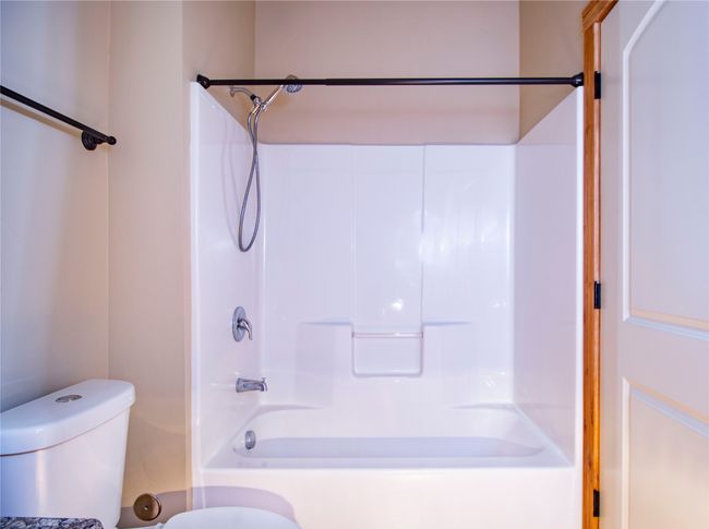 Full bathroom featuring toilet and bathing tub / shower combination | Image 15