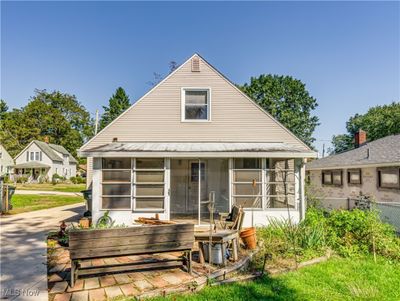 Back of home with screened in porch and brick patio | Image 3