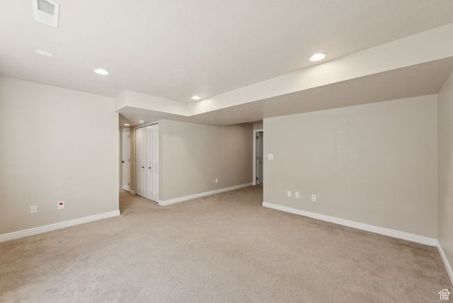 Finished below grade area with light colored carpet and recessed lighting | Image 37