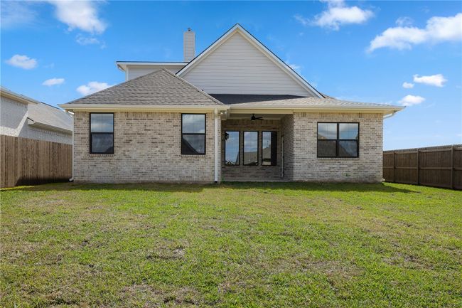Rear view of house with a lawn and ceiling fan | Image 29