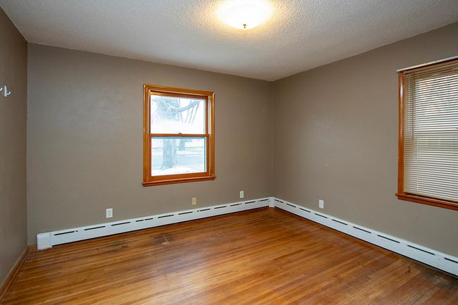 Primary bedroom with hardwood floors! | Image 9