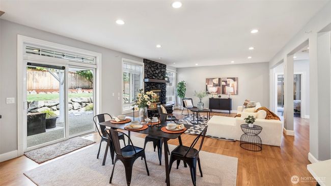 A large glass sliding door is conveniently located at the center of the home near the dining area, which seamlessly flows into the spacious, open-concept second living room with an elegant design | Image 18