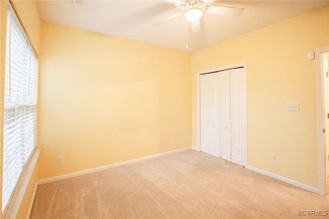 Unfurnished bedroom with light carpet, baseboards, and a closet | Image 11