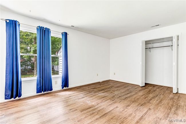 Unfurnished bedroom featuring wood finished floors and a closet | Image 13