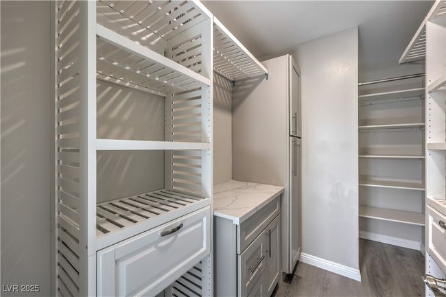 Walk in closet featuring dark wood finished floors | Image 30