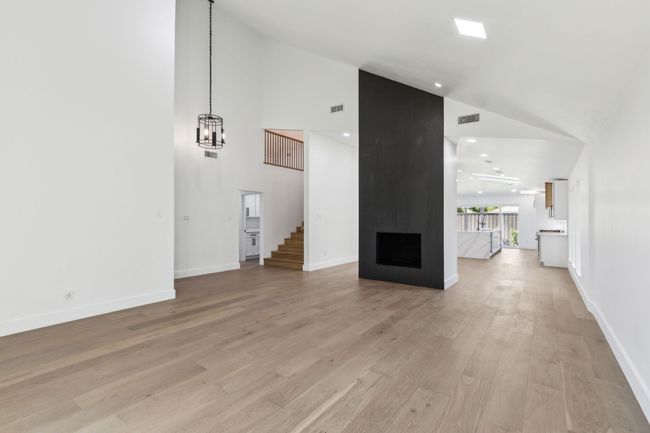 Custom lighting and floor to ceiling tiled gas fireplace. | Image 6