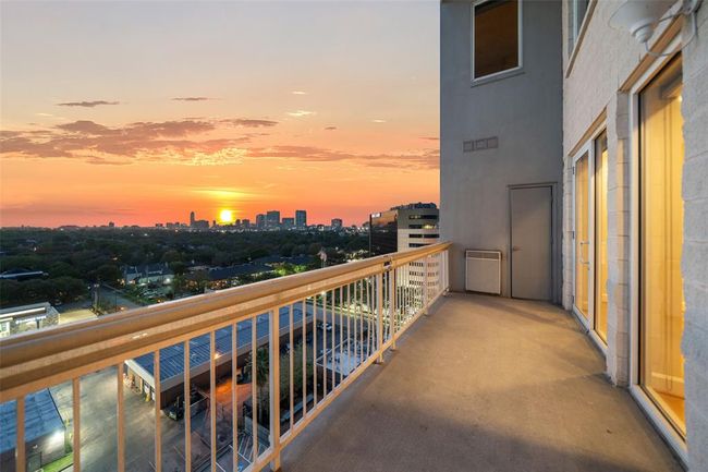 Experience breathtaking sunsets and cityscape views from this spacious balcony, perfect for relaxation and entertaining. | Image 8