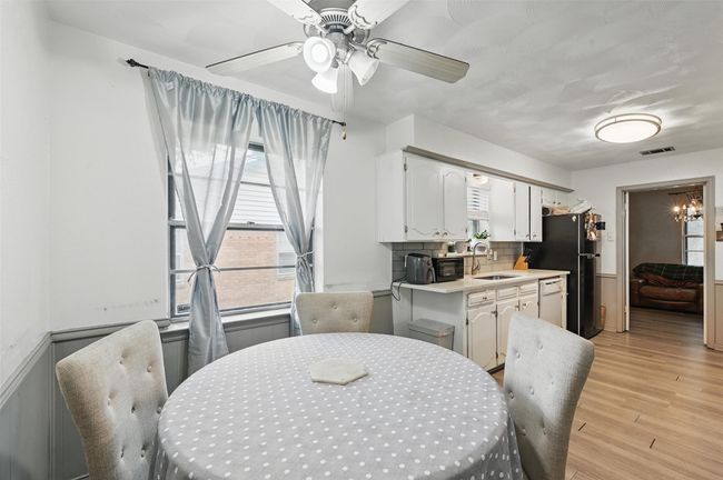 Dining space featuring light wood-style floors and a ceiling fan | Image 11