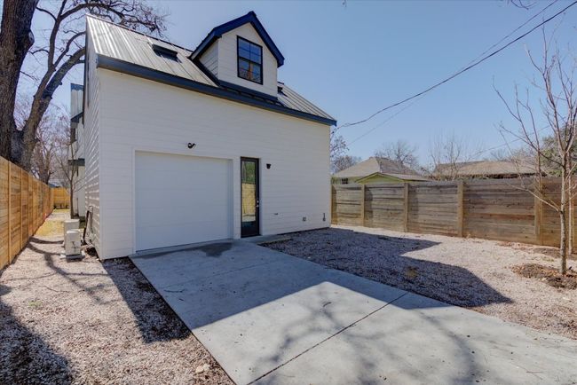 In addition to the garage, there is ample room for two more cars to park on the limestone area to the right of the driveway. The electric gate provides further security. | Image 35