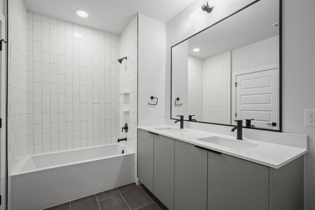 Bathroom featuring tile patterned flooring, double vanity, bathing tub / shower combination, and recessed lighting | Image 14
