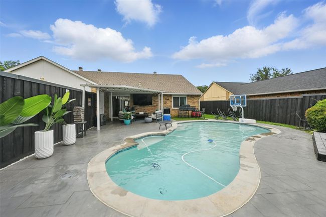 View of pool with a patio area, a fenced backyard, and an outdoor living space | Image 31