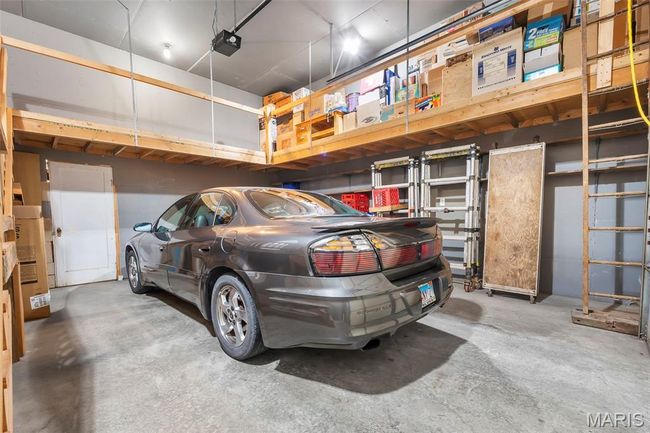 Garage featuring a garage door opener | Image 57