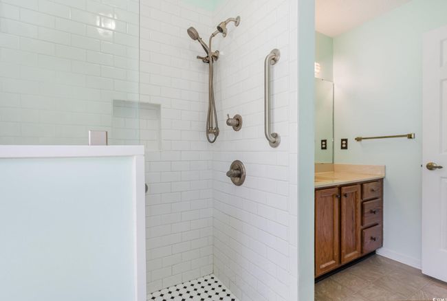 Full bathroom featuring a tile shower, tile patterned flooring, and vanity | Image 26