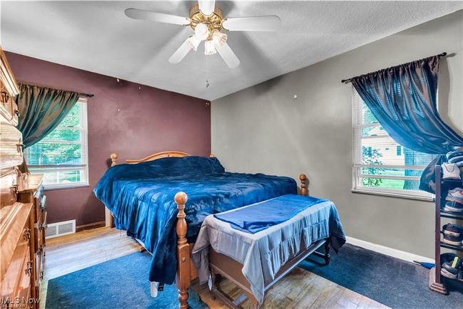 Bedroom with wood finished floors, baseboards, and ceiling fan | Image 22