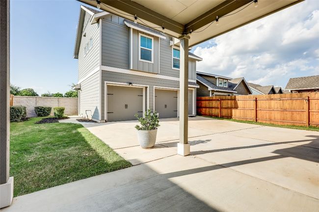 View of patio with concrete driveway and a garage | Image 27