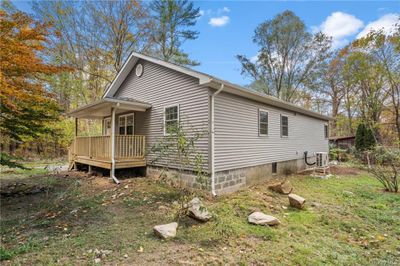 View of side of home with a wooden deck and central air condition unit | Image 2