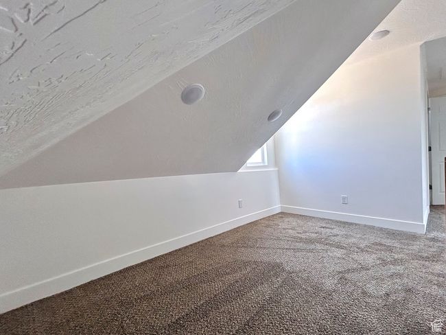 Bonus room featuring carpet, vaulted ceiling, and baseboards | Image 19