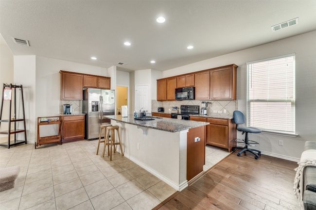 Here one can notice the ample island in the kitchen that can also function nicely as a breakfast bar | Image 11