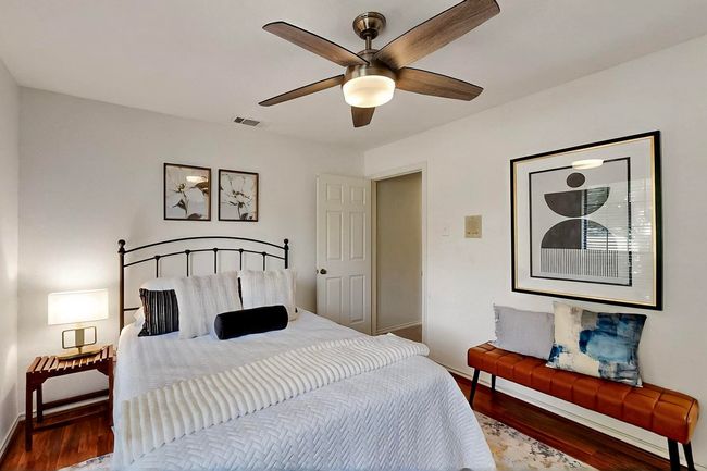 Bedroom with wood finished floors and ceiling fan | Image 28