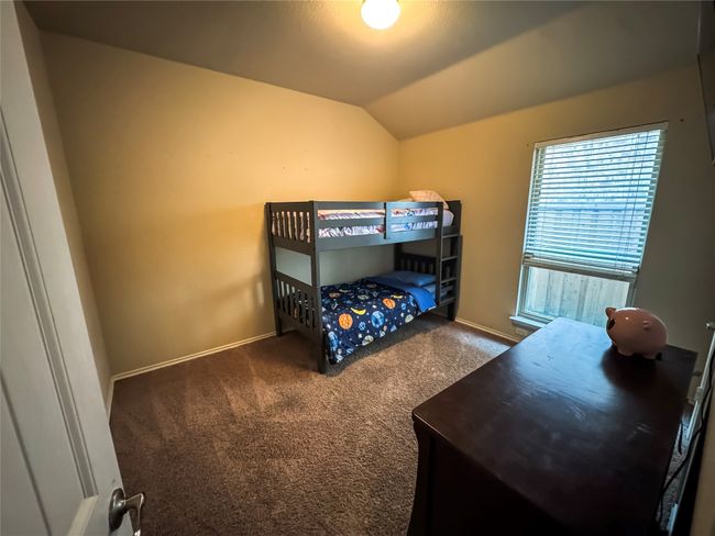 Carpeted bedroom with baseboards and vaulted ceiling | Image 17
