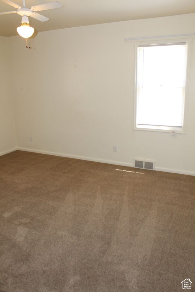 Unfurnished room featuring carpet and a ceiling fan | Image 32
