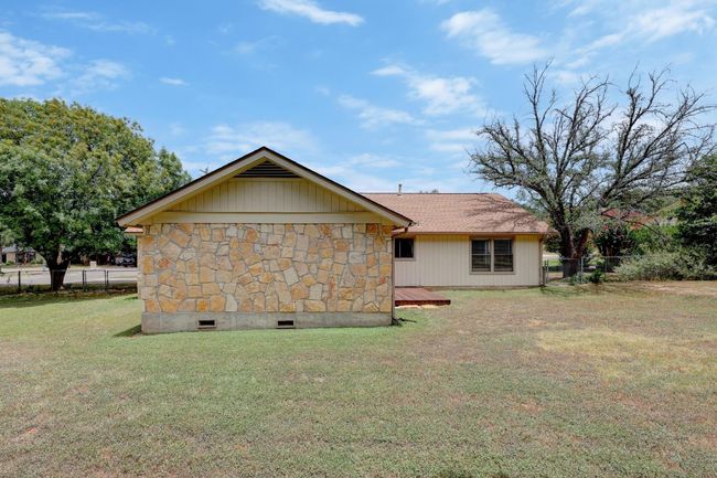 View of side of property featuring stone siding and a deck | Image 23