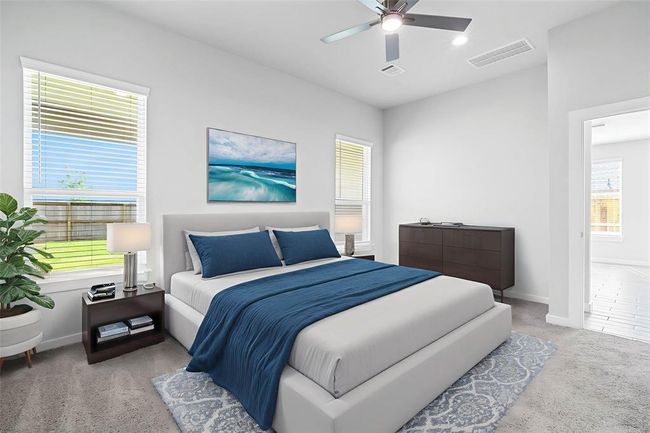 Come and unwind after a long day in this magnificent primary suite! This spacious room features plush carpet, warm paint, high ceilings, ceiling fan, and large windows with privacy blinds. | Image 10