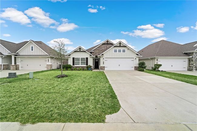 Craftsman inspired home featuring driveway, a front yard, stone siding, and board and batten siding | Image 34