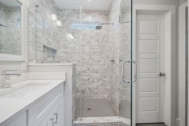 Bathroom featuring a stall shower and vanity | Image 24