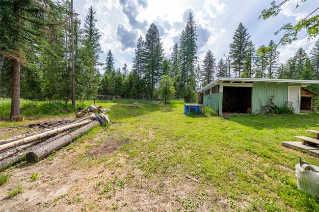 View of green lawn featuring an outbuilding and an outdoor structure | Image 50