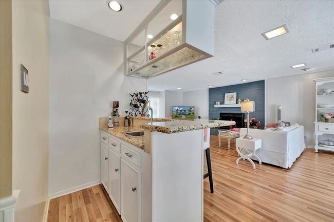 Another view of the family room also showing the wet bar. So much storage for your favorite things! | Image 17