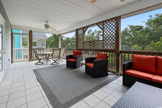 Sunroom with a ceiling fan, an outdoor hangout area, and outdoor dining space | Image 32
