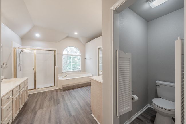 Large primary bathroom with separate shower, jetted tub, and double vanity. | Image 23