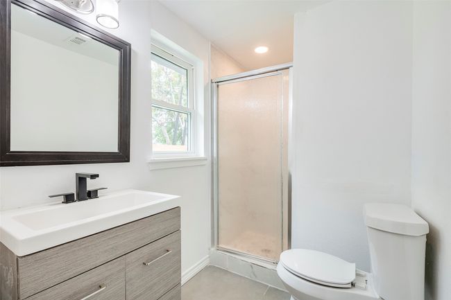 Bathroom featuring vanity, a shower stall, and tile patterned floors | Image 24