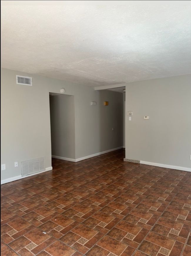 Empty room with a textured ceiling and a smoke detector | Image 11
